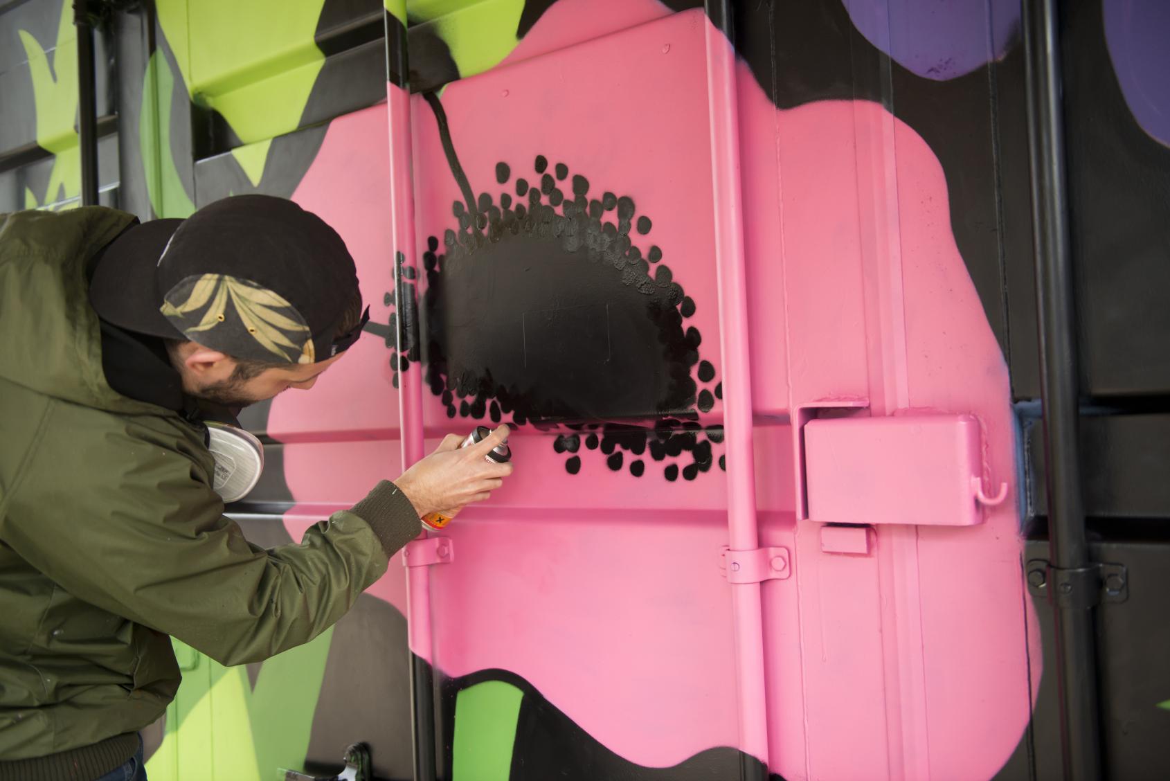 Wildflower art, The Bearpit Bristol Participant spray painting a wildflower mural